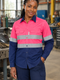 African woman wearing the pink-and-navy work shirt